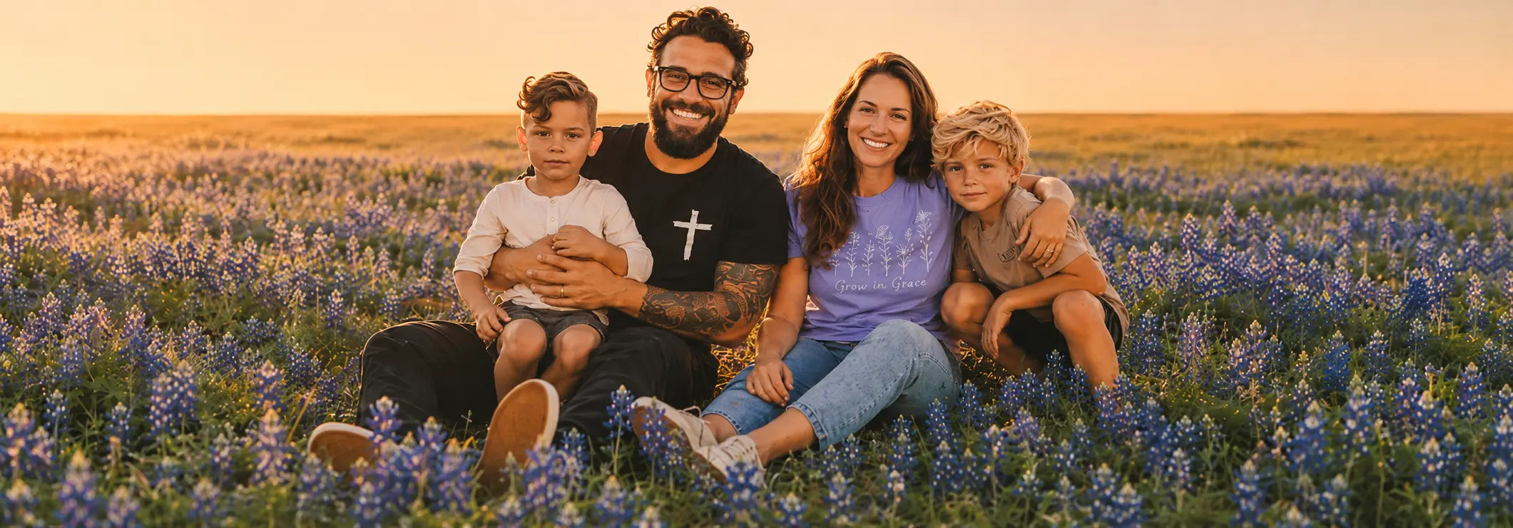 Andrew Melissa and kids sitting in a field of blue bonnets at sunset